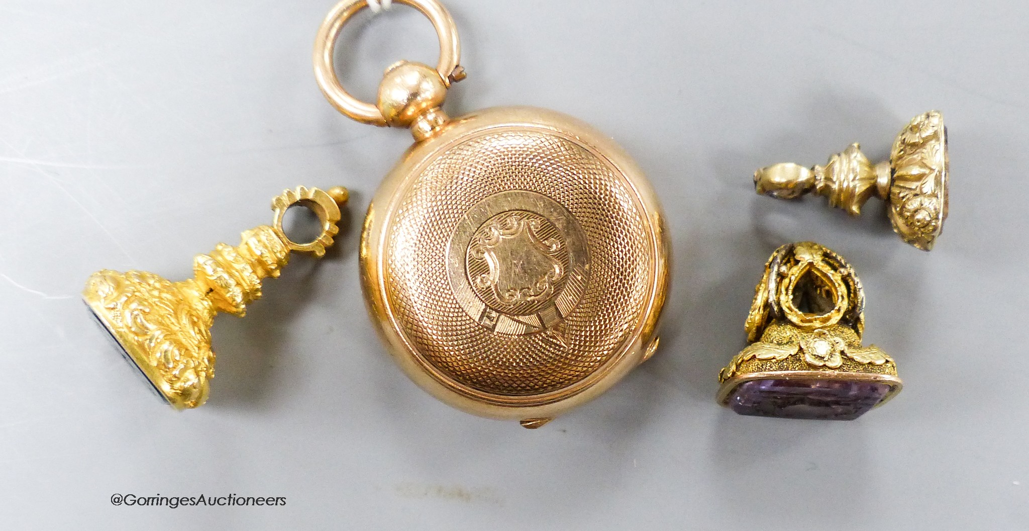A gold plated sovereign case and three assorted yellow metal overlaid and gem set fob seals (one a.f.) including two with carved matrix, largest 26mm.
